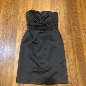 Great black strapless cocktail dress with boning around the chest.